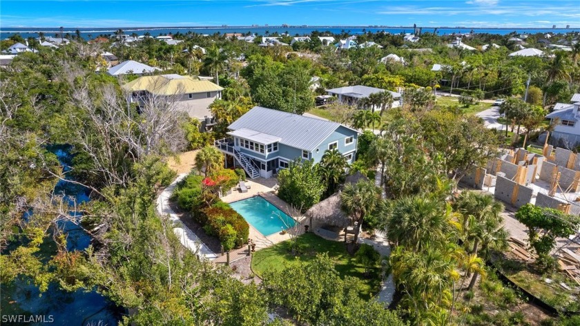 This stunning home is located on intersecting canals on - Beach Home for sale in Sanibel, Florida on Beachhouse.com