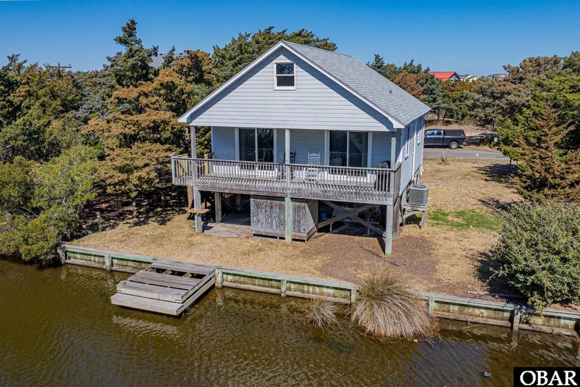 Tucked along a peaceful canal in the heart of Avon, this - Beach Home for sale in Avon, North Carolina on Beachhouse.com
