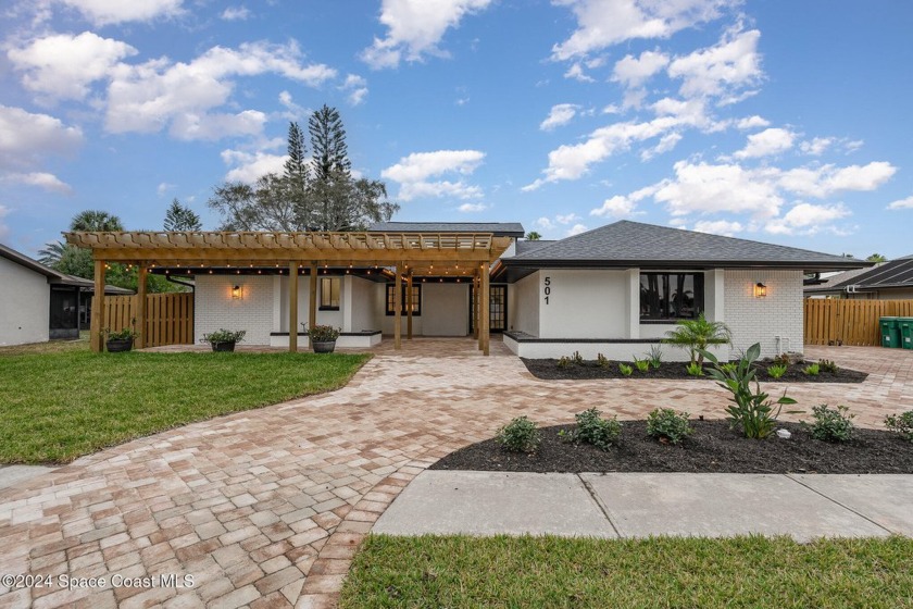 Discover the epitome of modern coastal living in this impeccably - Beach Home for sale in Indian Harbour Beach, Florida on Beachhouse.com