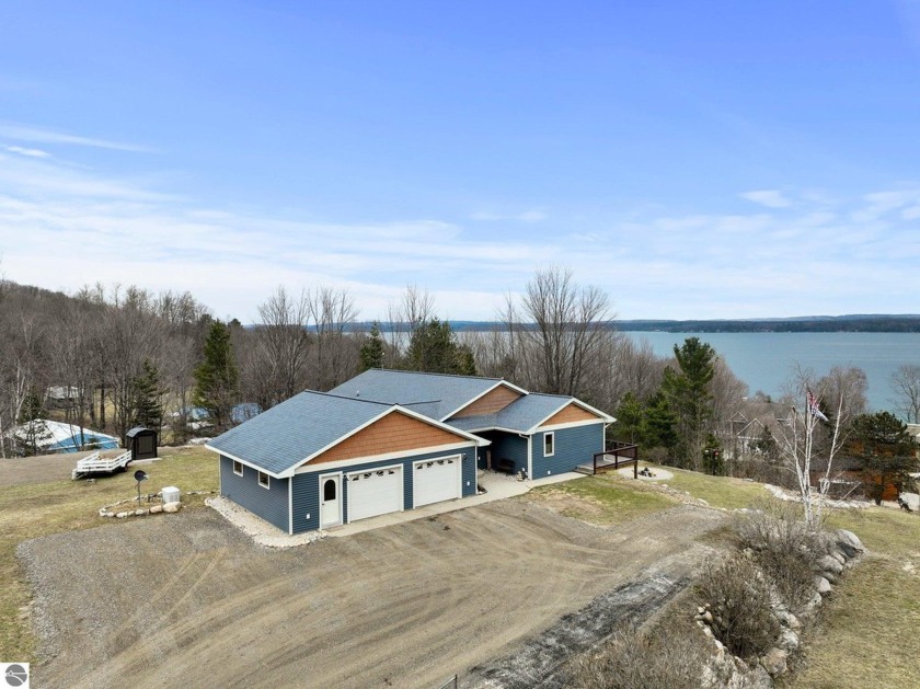 Nestled atop a hill and surrounded by 3.5 acres of privacy, this - Beach Home for sale in Kewadin, Michigan on Beachhouse.com