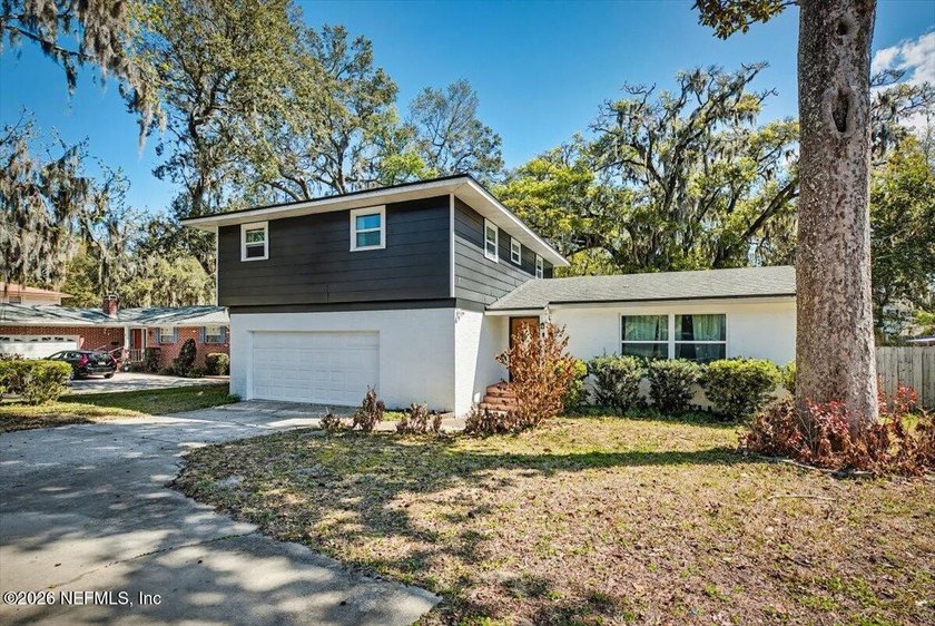 Charming split-level home nestled beneath mature oak trees in an - Beach Home for sale in Jacksonville, Florida on Beachhouse.com