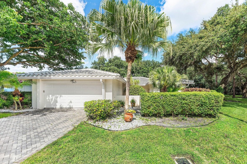 Set on a quiet tree-lined lot in Hampshire at Hunters Run - Beach Home for sale in Boynton Beach, Florida on Beachhouse.com