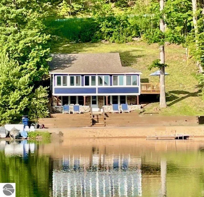 Nestled among the trees, perched upon a hill sits Little Blue on - Beach Home for sale in Traverse City, Michigan on Beachhouse.com