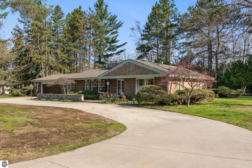This ranch-style home in Charlevoix, MI, is ideally situated on - Beach Home for sale in Charlevoix, Michigan on Beachhouse.com