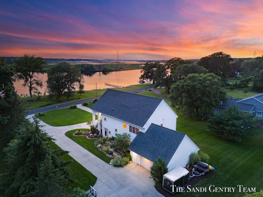 Discover serene waterfront living with 150 feet of frontage on - Beach Home for sale in Spring Lake, Michigan on Beachhouse.com