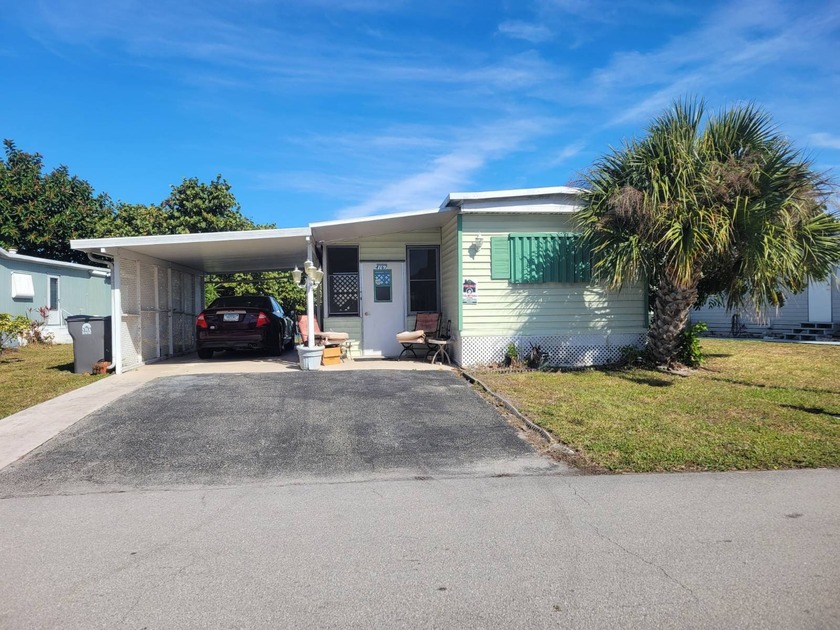 This one-of-a-kind single-wide offers a rare bump-out design - Beach Lot for sale in West Palm Beach, Florida on Beachhouse.com