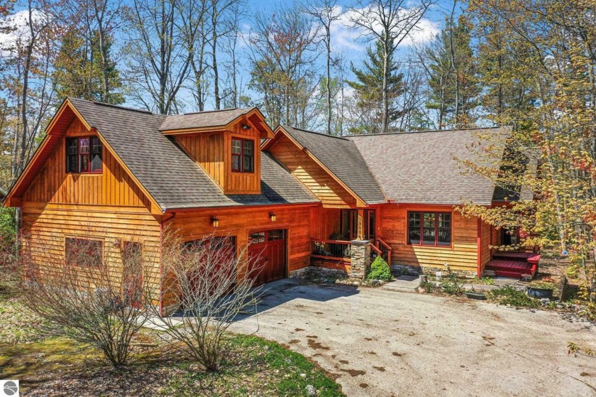 Nestled on a serene, wooded lot just a short stroll from East - Beach Home for sale in Kewadin, Michigan on Beachhouse.com