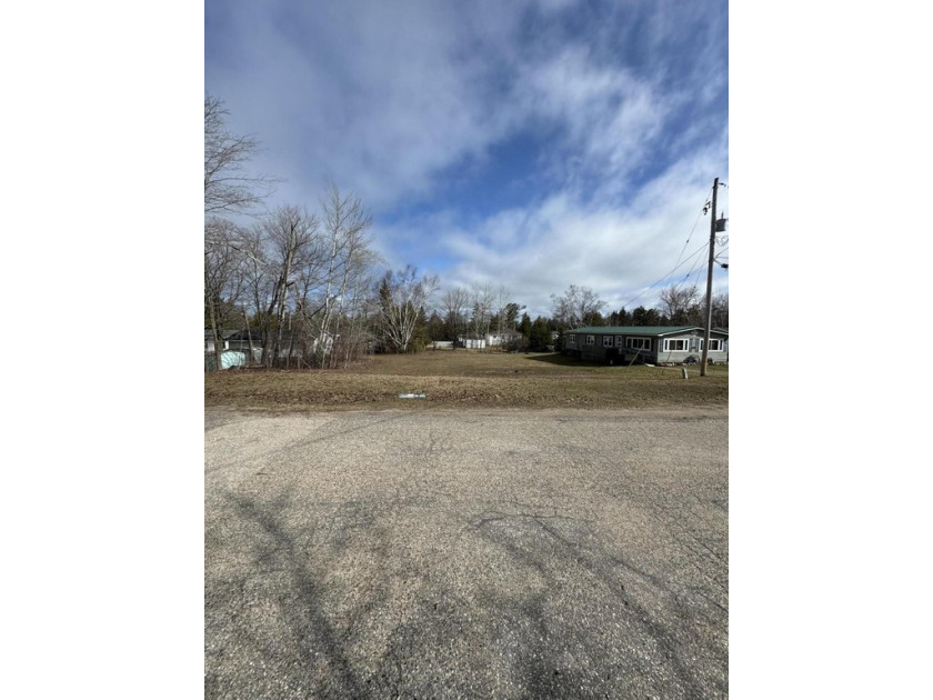 This 0.34 acre wooded lot (100'x150') offers a prime location in - Beach Lot for sale in Mackinaw City, Michigan on Beachhouse.com