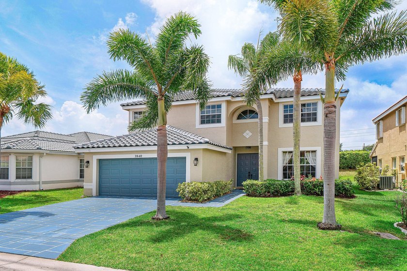 Framed by swaying palm trees and lush landscaping, this - Beach Home for sale in Boynton Beach, Florida on Beachhouse.com