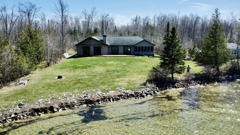 Located on highly sought after all-sports Grand Lake, this - Beach Home for sale in Presque Isle, Michigan on Beachhouse.com