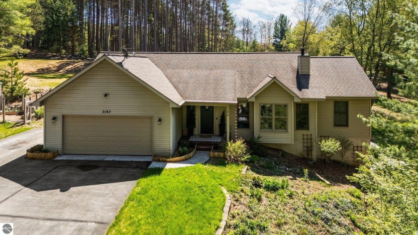 Tucked away on a wooded 5.65-acre parcel, this spacious 4 bed/3 - Beach Home for sale in Traverse City, Michigan on Beachhouse.com