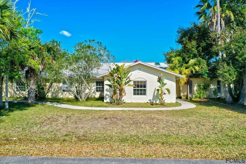 RARE FIND! Situated on a DOUBLE LOT with 155ft of SALT WATER - Beach Home for sale in Palm Coast, Florida on Beachhouse.com