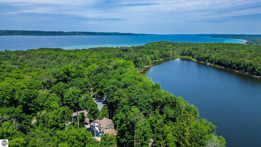 Nestled on nearly 1.5 acres of secluded waterfront, this - Beach Home for sale in Alden, Michigan on Beachhouse.com