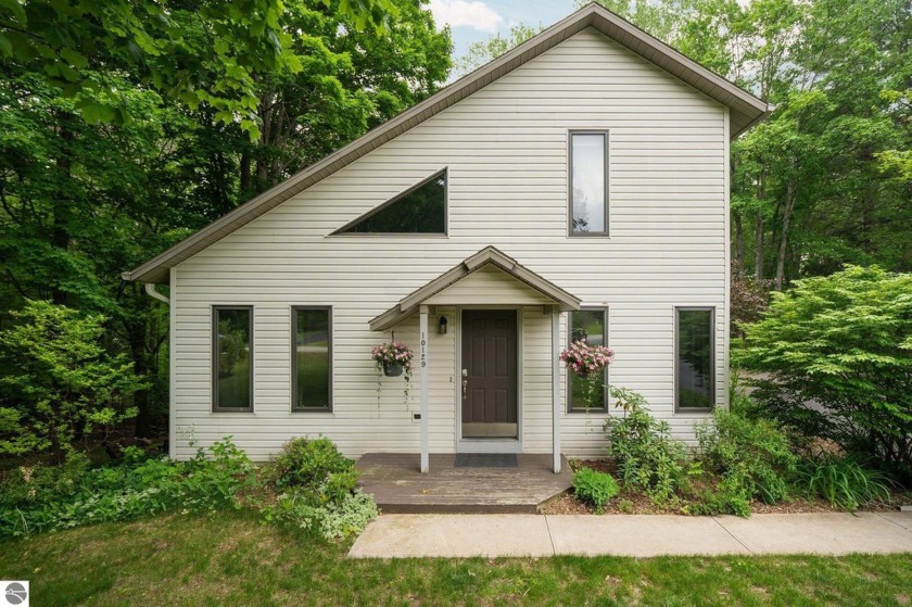 Tucked among the trees on 2.40 acres, this thoughtfully updated - Beach Home for sale in Traverse City, Michigan on Beachhouse.com