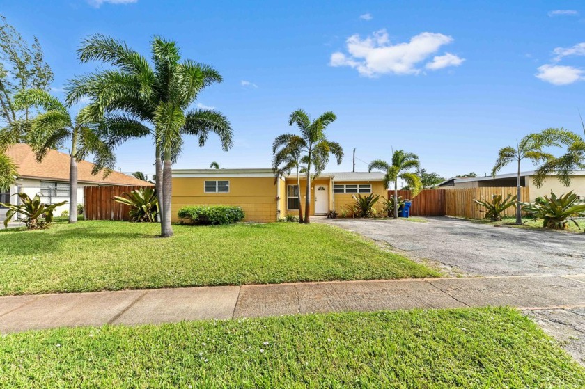 Welcome to this charming, single-story pool home offering 1,272 - Beach Home for sale in Riviera Beach, Florida on Beachhouse.com