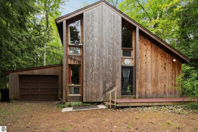 Tucked away in the serene woodlands of Northport, this charming - Beach Home for sale in Northport, Michigan on Beachhouse.com
