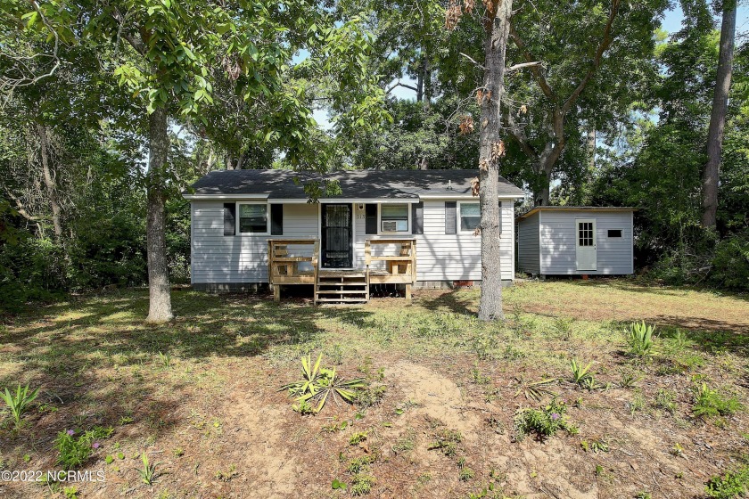 This cozy bungalow on the island is nestled on a wooded lot with - Beach Home for sale in Oak Island, North Carolina on Beachhouse.com