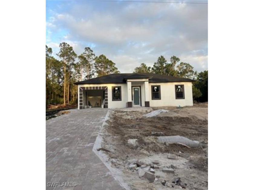 This beautiful home offers 3 bedrooms and 3 bathrooms, all - Beach Home for sale in Lehigh Acres, Florida on Beachhouse.com