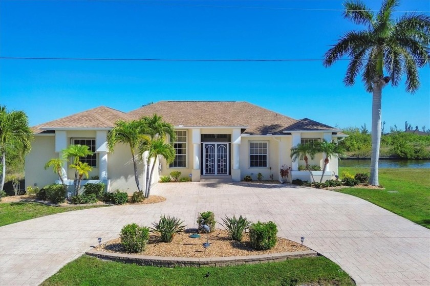 Welcome to your dream waterfront oasis on a DOUBLE LOT located - Beach Home for sale in Port Charlotte, Florida on Beachhouse.com