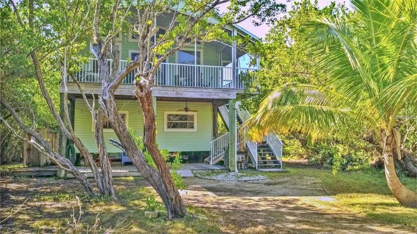 Island life awaits you! This charming 3 bed/2.5 bath stilt-style - Beach Home for sale in Placida, Florida on Beachhouse.com