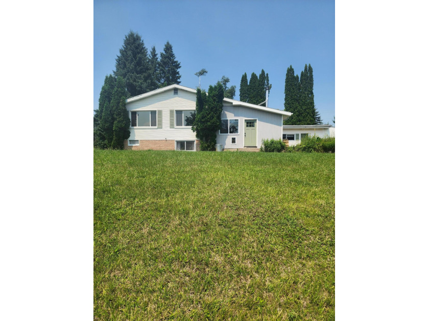 This home with beautiful frontage, on Thunder Bay River - Beach Home for sale in Alpena, Michigan on Beachhouse.com