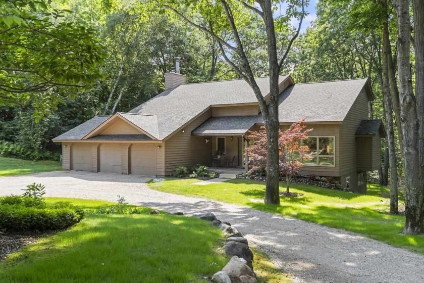 Nestled on a private 9-acre wooded lot, this home with large - Beach Home for sale in Petoskey, Michigan on Beachhouse.com