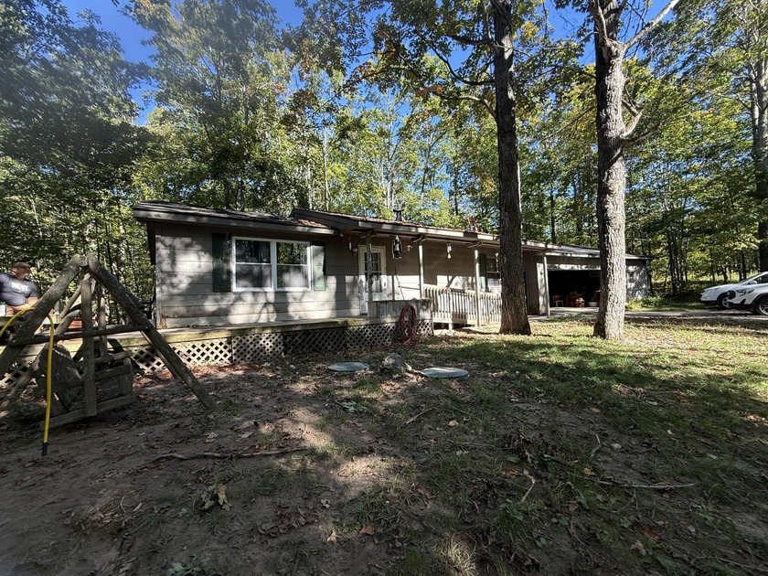 Nestled among the trees and surrounded by nature, this well-kept - Beach Home for sale in Alanson, Michigan on Beachhouse.com