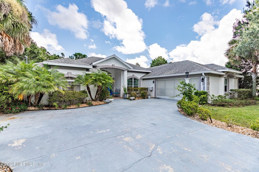 CREEKSIDE POOL HOME ON OVER A QUARTER ACRE LOT! Relax in this - Beach Home for sale in Palm Coast, Florida on Beachhouse.com