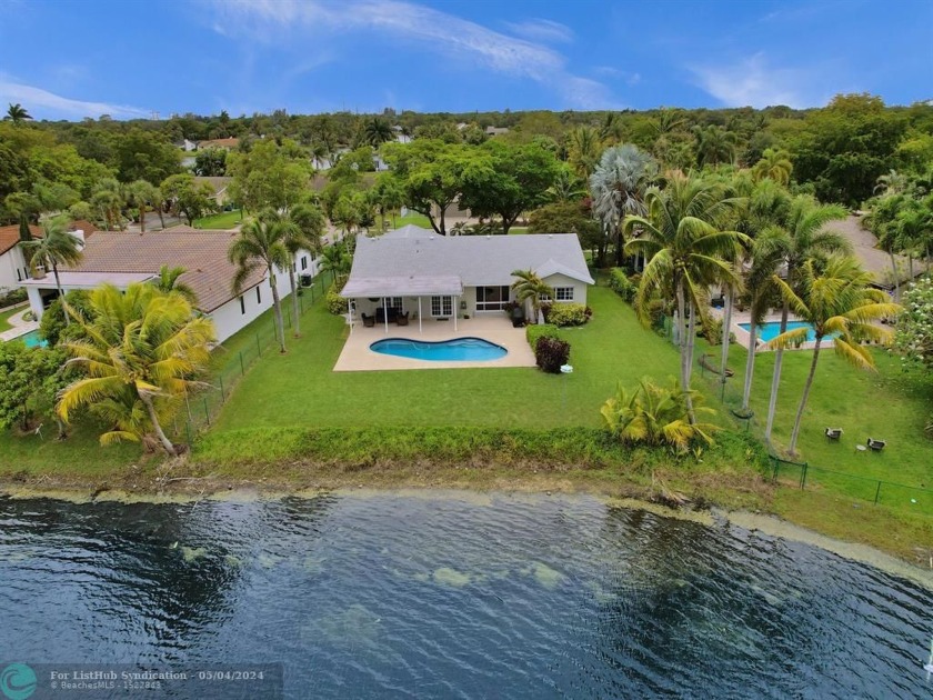 Introducing a captivating waterfront home nestled in the heart - Beach Home for sale in Cooper City, Florida on Beachhouse.com