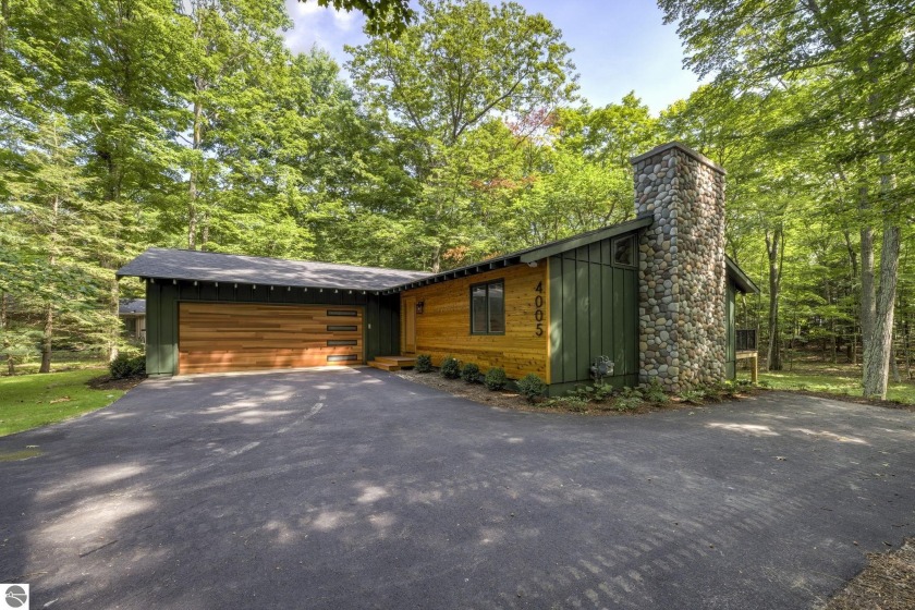 This beautifully remodeled home offers modern comfort and - Beach Home for sale in Leland, Michigan on Beachhouse.com