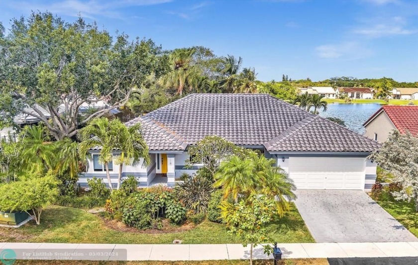 Welcome to this spacious 4-bed, 3-bath lakefront home in the - Beach Home for sale in Davie, Florida on Beachhouse.com
