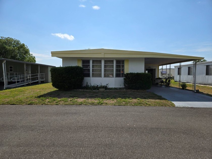 THIS LOVELY 2/2 IS MOVE IN READY. NEWER FLOORING, NEWER A/C - Beach Home for sale in New Port Richey, Florida on Beachhouse.com