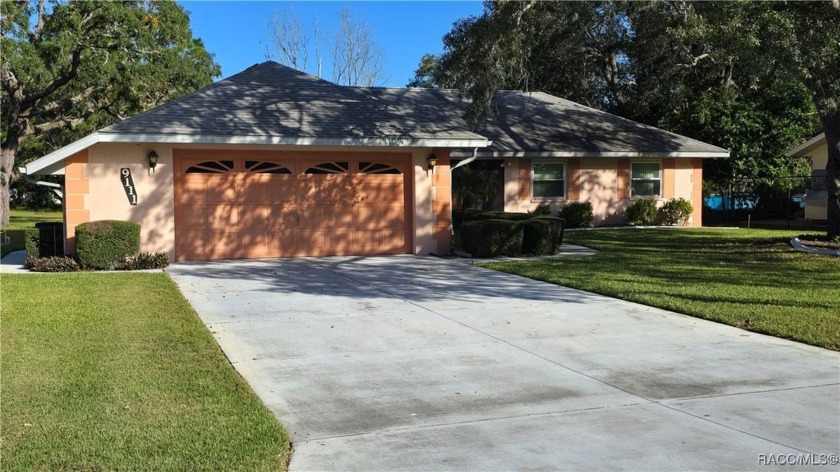 Nestled beneath the welcoming shade of majestic trees, this - Beach Home for sale in Spring Hill, Florida on Beachhouse.com