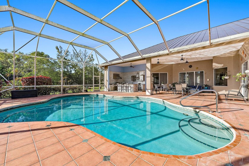 Nestled on 2.5 private acres, this beautifully updated estate - Beach Home for sale in West Palm Beach, Florida on Beachhouse.com