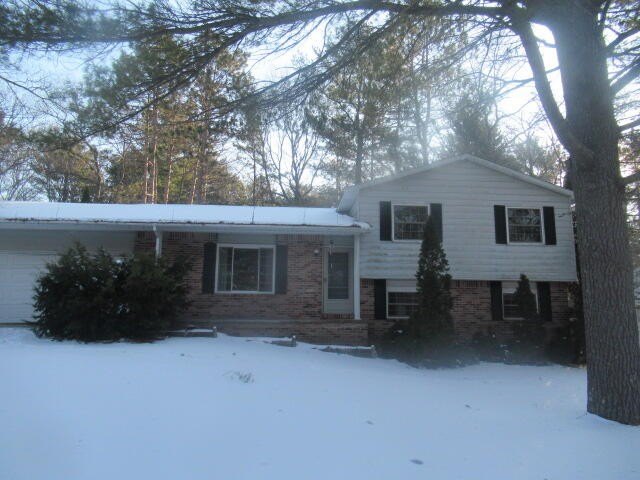 This bi-level home with attached garage and partial basement has - Beach Home for sale in Oscoda, Michigan on Beachhouse.com