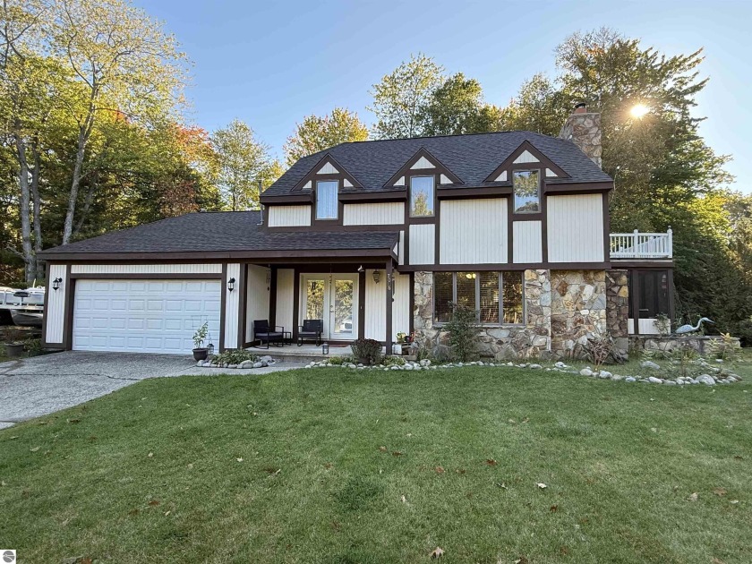 This 3-bedroom, 2.5-bath Tudor welcomes you with timeless charm - Beach Home for sale in Oscoda, Michigan on Beachhouse.com