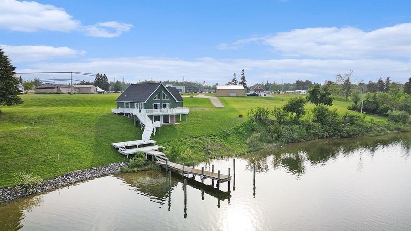 Enjoy stunning Cheboygan River views from this inviting - Beach Home for sale in Cheboygan, Michigan on Beachhouse.com