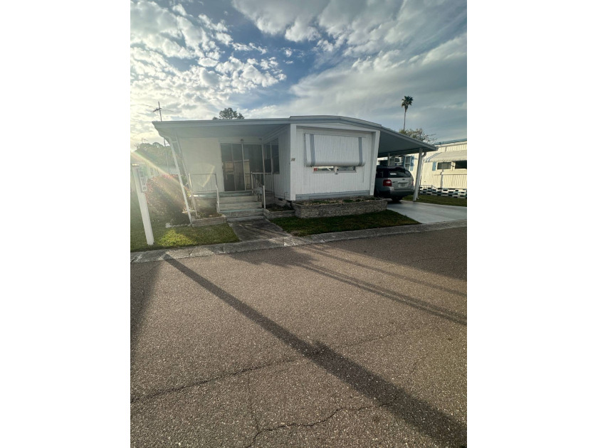 Nestled within the charming Lake Bonbon RV Park in Pinellas Park - Beach Home for sale in St. Petersburg, Florida on Beachhouse.com