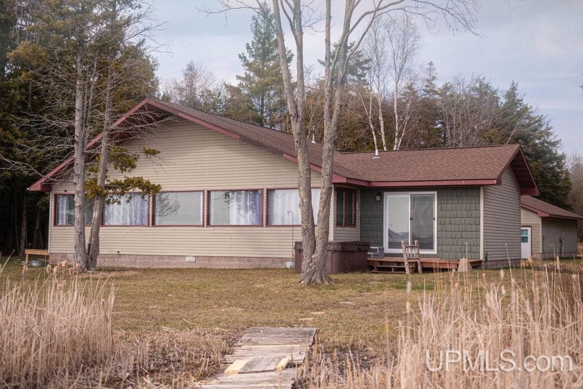 Discover the charm of lakeside living in this serene Indian Lake - Beach Home for sale in Manistique, Michigan on Beachhouse.com