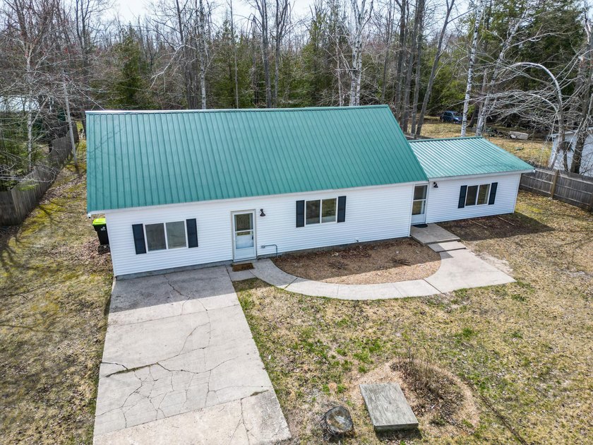 Up North charm meets modern updates in this recently remodeled - Beach Home for sale in Cheboygan, Michigan on Beachhouse.com