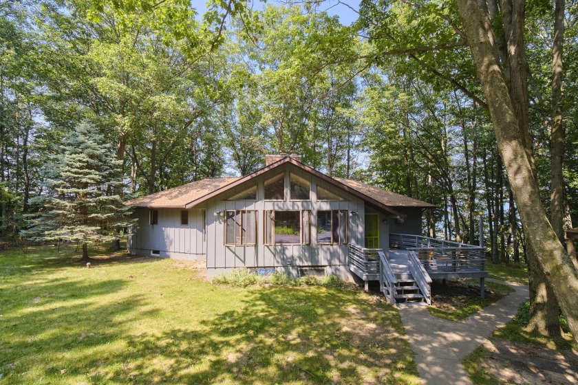 Perched on a hilltop overlooking Portage Lake with 300' of - Beach Home for sale in Manistee, Michigan on Beachhouse.com