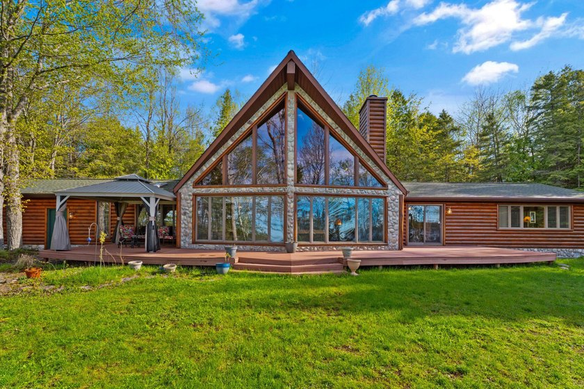 Tucked beneath a canopy of towering trees and surrounded by 4.16 - Beach Home for sale in Alpena, Michigan on Beachhouse.com