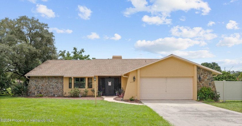 This inviting three-bedroom, three-bathroom home with a two-car - Beach Home for sale in Spring Hill, Florida on Beachhouse.com