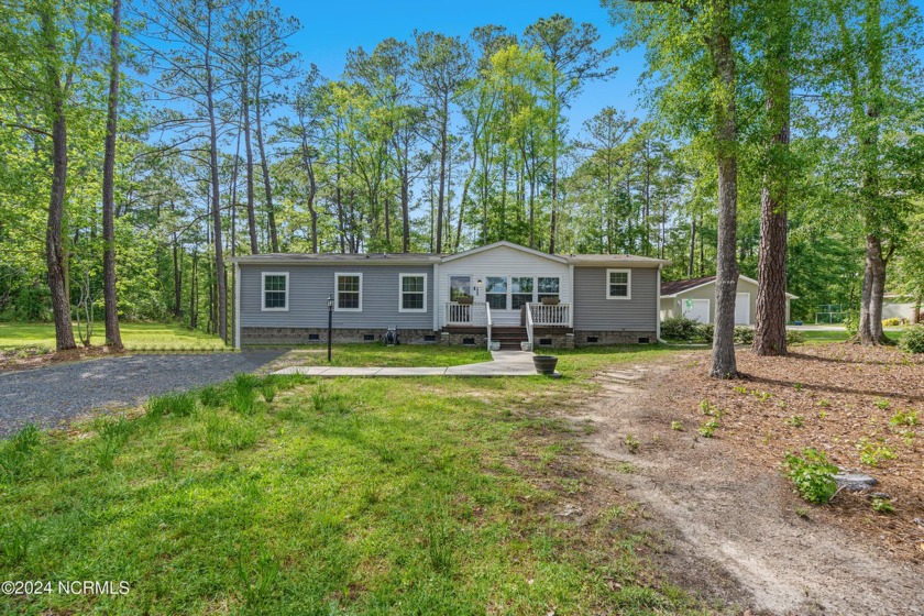 Welcome to a delightful three-bedroom, two-bathroom haven - Beach Home for sale in Calabash, North Carolina on Beachhouse.com