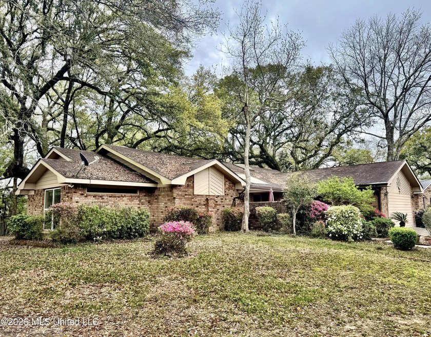 Located in the heart of Diamondhead, this spacious home sits on - Beach Home for sale in Diamondhead, Mississippi on Beachhouse.com