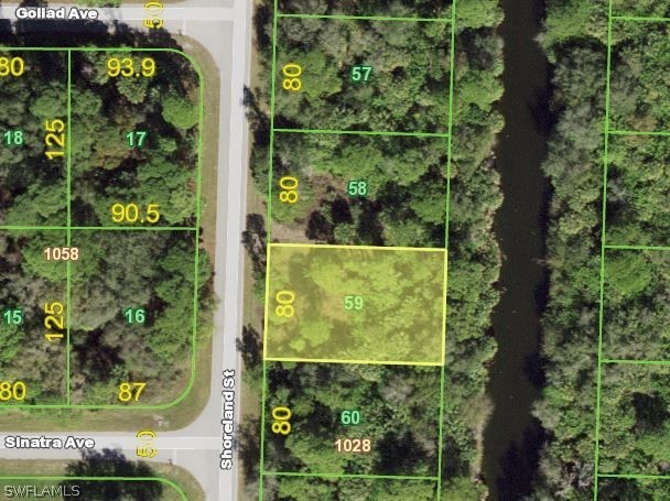 Very nice wooded lot on a canal in fast growing area take - Beach Lot for sale in Port Charlotte, Florida on Beachhouse.com