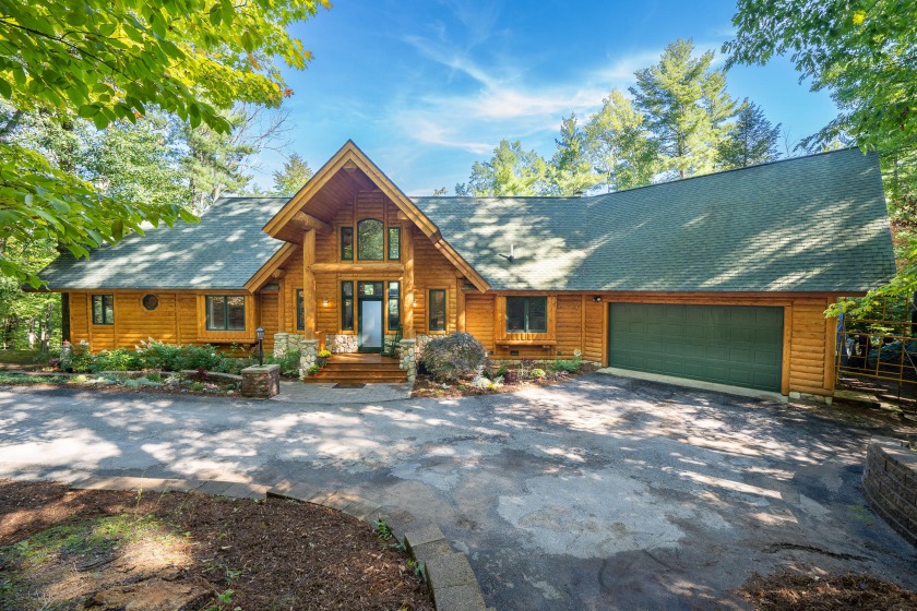 STUNNING BEAUTY IN THIS CUSTOM BUILT LOG HOME ON ARBUTUS LAKE! - Beach Home for sale in Traverse City, Michigan on Beachhouse.com