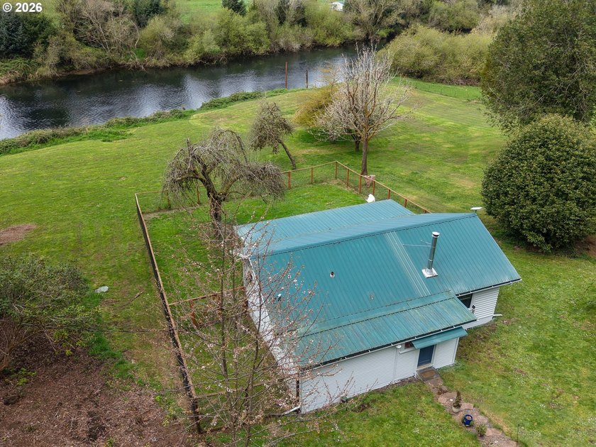 Charming riverfront cottage on one acre with 130' of Coos River - Beach Home for sale in Coos Bay, Oregon on Beachhouse.com