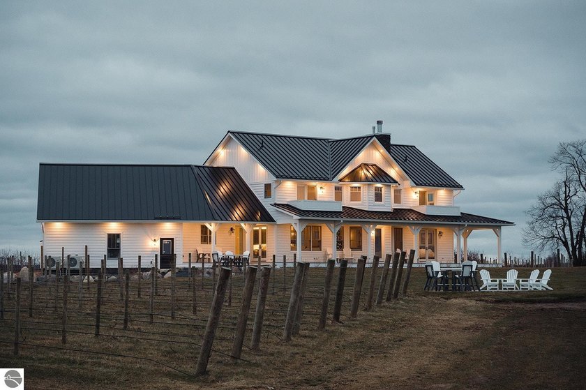 Set on 5 picturesque acres in Williamsburg, Michigan, this - Beach Home for sale in Williamsburg, Michigan on Beachhouse.com