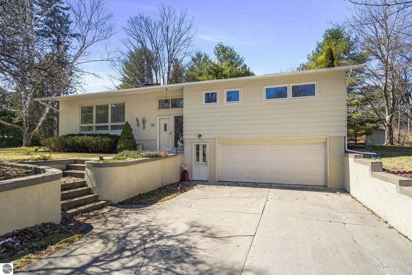 Discover timeless style and an unbeatable location in this - Beach Home for sale in Traverse City, Michigan on Beachhouse.com